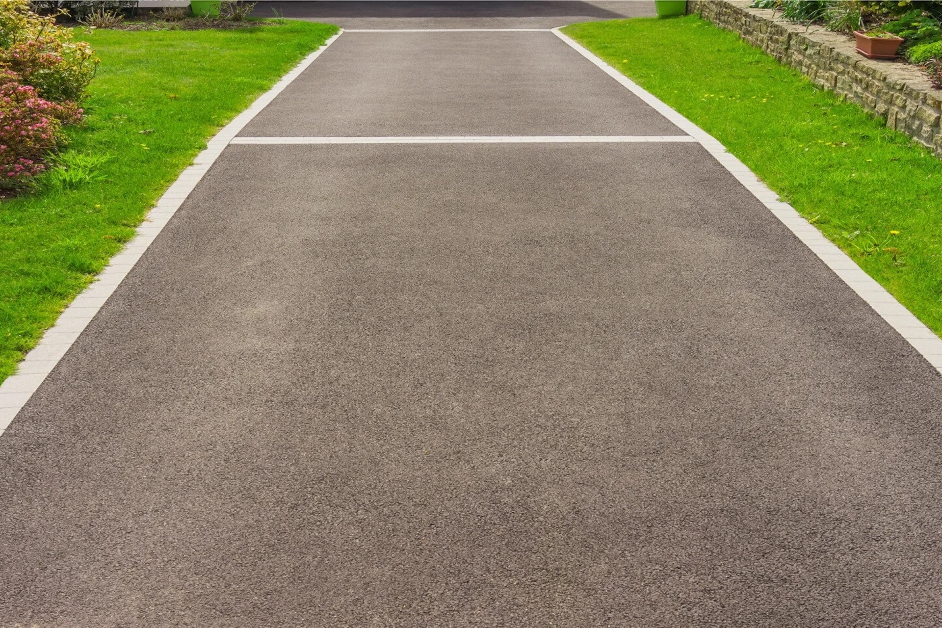 Completed asphalt driveway ready for service.